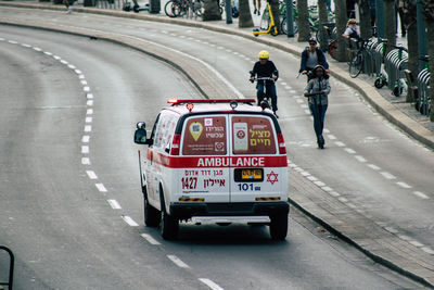 People riding motorcycle on road