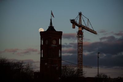 Silhouette of tower against cloudy sky