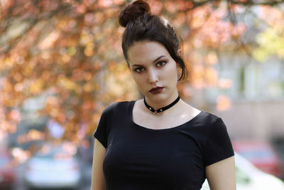 Portrait of confident woman standing at park