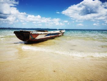 Nautical vessel on sea shore against sky