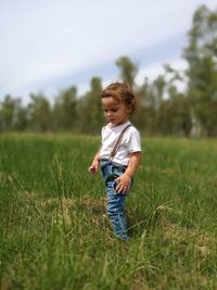 Side view of boy standing on field