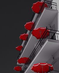 Low angle view of red flags against clear sky