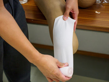 Midsection of woman preparing food on table at home