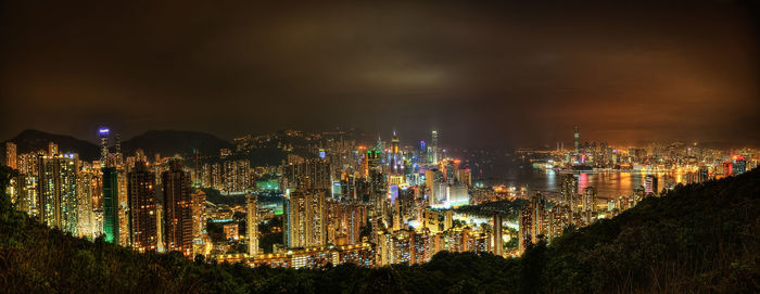 High angle view of illuminated buildings against sky at night