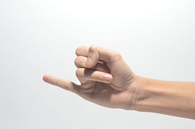Close-up of human hand against white background