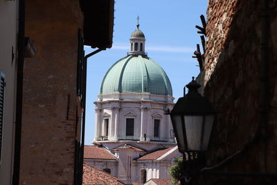 Cathedral amidst buildings against sky