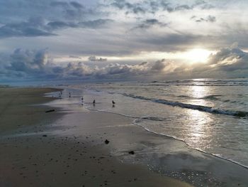 Scenic view of beach against sky during sunset