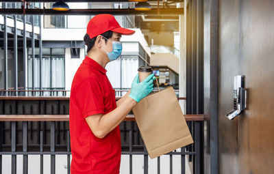 Side view of man working with umbrella