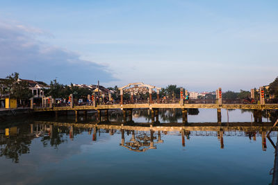 Reflection of buildings in lake against sky