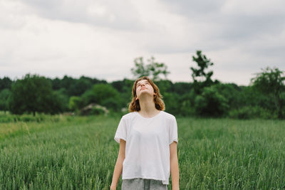 Happy cheerful teen girl with pronounced face dancing in outdoors.