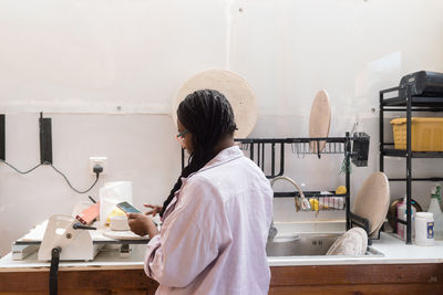 Woman washing her pottery at the ceramics studio