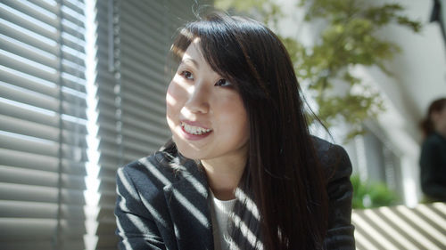 Portrait of smiling young woman looking away