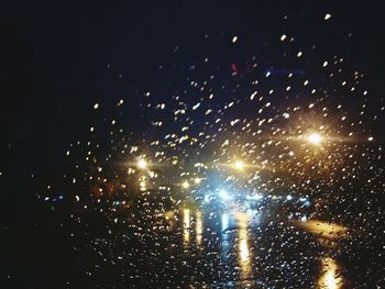 Firework display against sky at night during winter