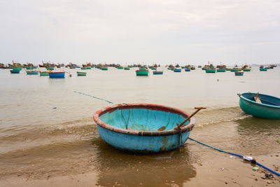 Boats in sea against sky