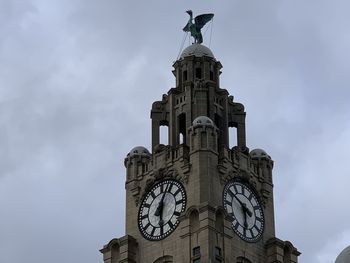 Low angle view of clock tower against sky