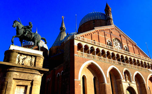 Low angle view of building against clear blue sky