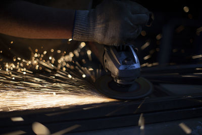 Steel processing. metal cutting. sparks from friction. fire in dark. details of work.