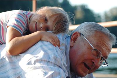 Grandfather carrying granddaughter on back