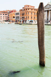 River amidst buildings against clear sky