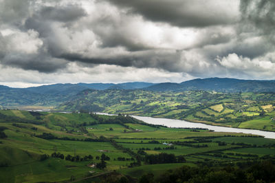 Scenic view of agricultural field against sky