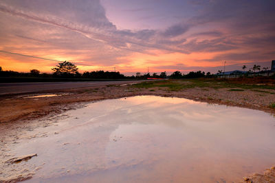 Scenic view of field against sky during sunset