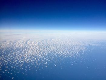 Scenic view of snowcapped landscape against clear blue sky