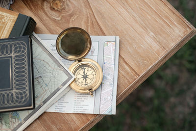 High angle view of navigational compass on paper