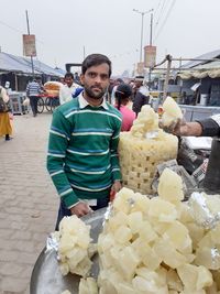 Portrait of man standing in market