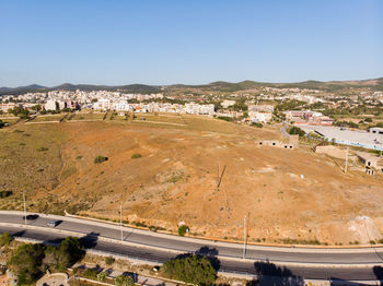 High angle view of road by buildings against sky