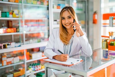 Businesswoman talking on phone in laboratory