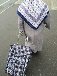 Rear view of woman walking with bag on street