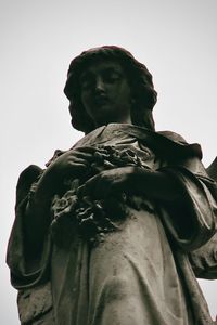 Low angle view of statue against sky