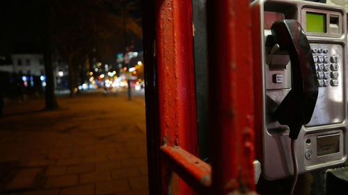 Pay phone in booth at night