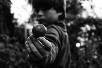 Boy holding tomato