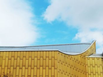 Low angle view of house roof against sky