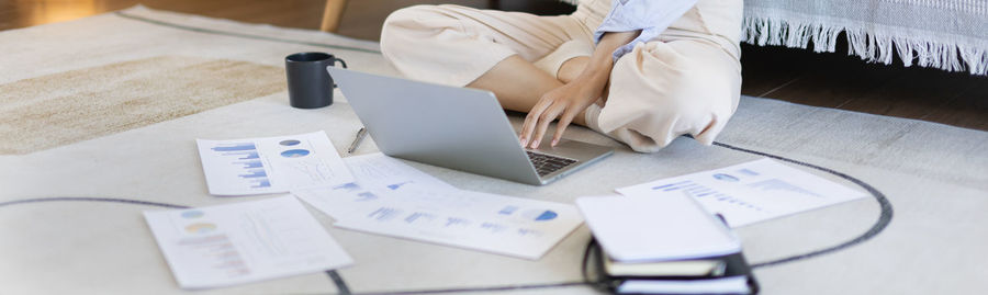 Midsection of businessman working on table