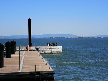 Scenic view of sea against clear blue sky