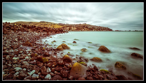 Scenic view of sea against cloudy sky