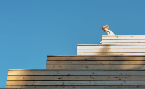 Low angle view of building against clear blue sky