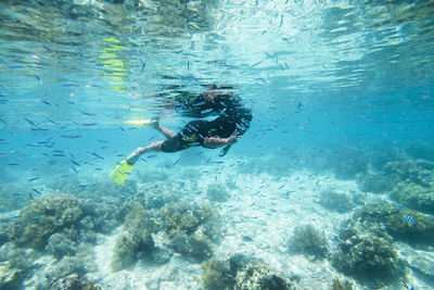 Man swimming in sea at mabul island,malaysia