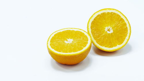 Close-up of orange fruit against white background