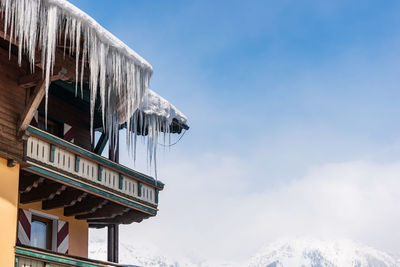 Low angle view of icicles on mountain against sky