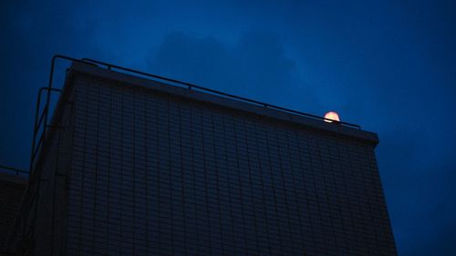 Low angle view of building against blue sky at dusk