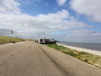Road by sea against sky