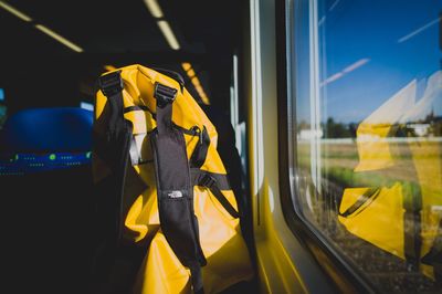 Backpack by window in train