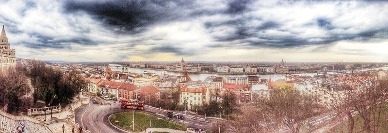 Cityscape against cloudy sky