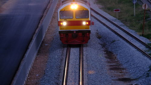 Train in illuminated railroad tracks during winter