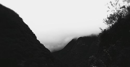 Scenic view of mountains against cloudy sky