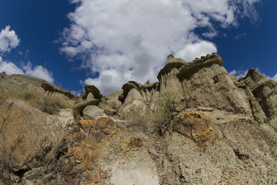 Low angle view of rock formation against sky