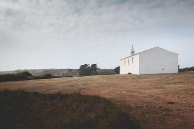 Built structure on field against sky